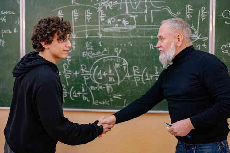 Student and professor shaking hands