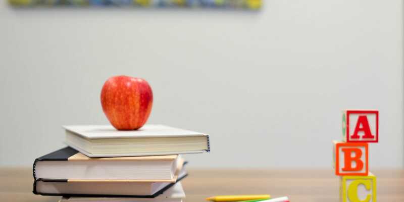 Books with an apple on top