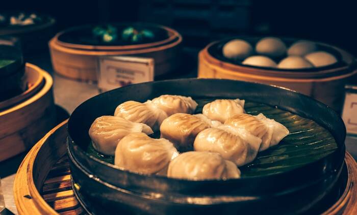 Chinese staple foods including steamed buns and dumplings arranged on bamboo steamers