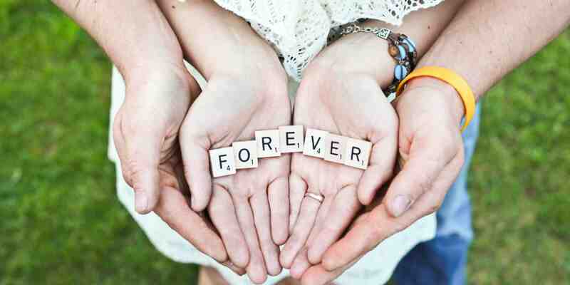 Two hands writing out forever with blocks