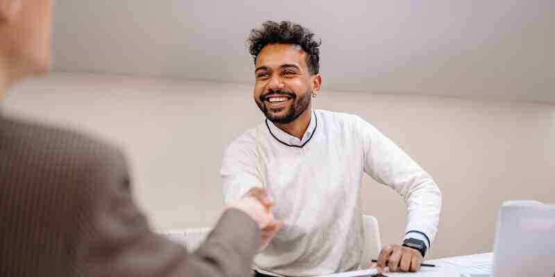 Smiling man shaking a hand