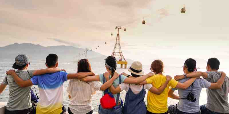 Friends embracing each other, looking out into the distance