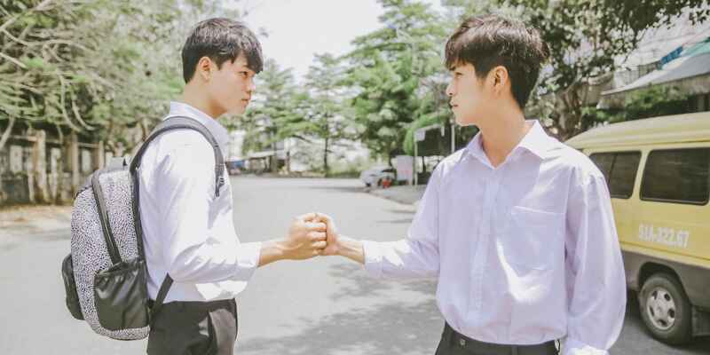 Two students saying hi to each other