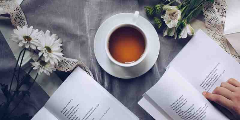 Cup of tea next to books