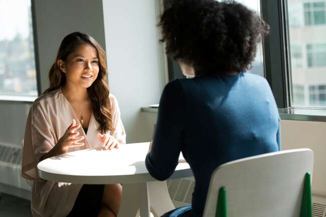 Two women talking face to face