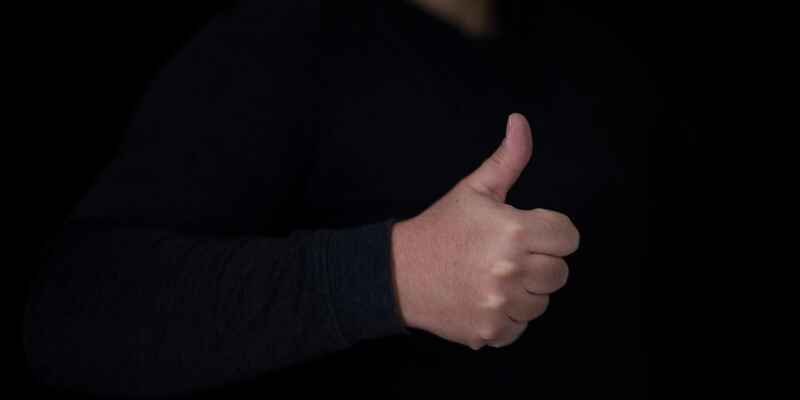 Thumbs up with black background