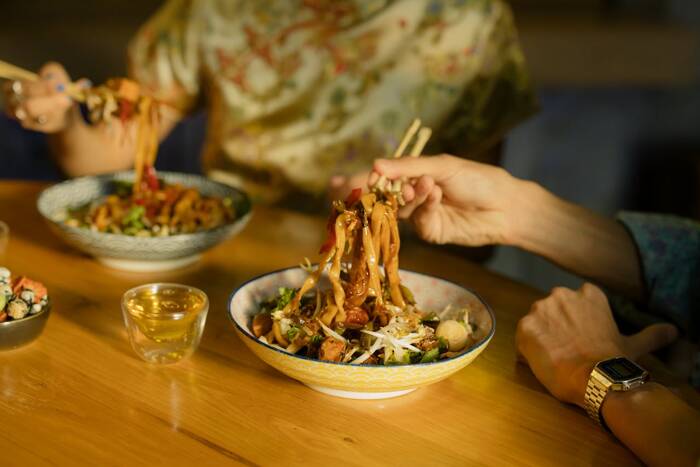 People eating food with chopsticks