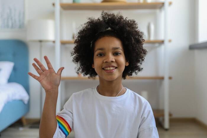 A girl waving hand as a greeting gesture