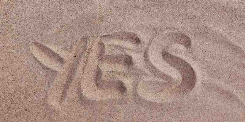 'yes' written in sand